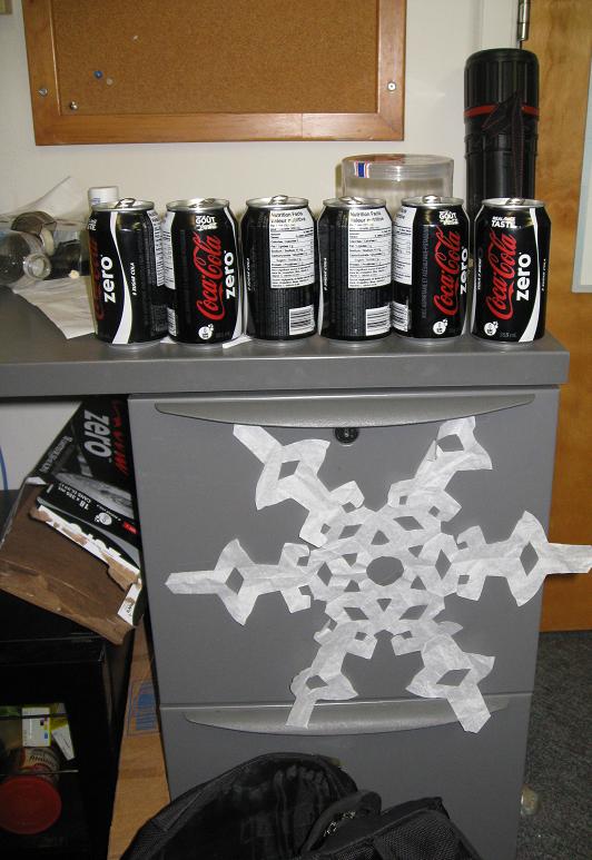 This oversized snowflake drew power from the filing cabinet and its Dark Contents. The filing cabinet already served as an altar, receiving daily offerings of Coke Zero tainted aluminum.